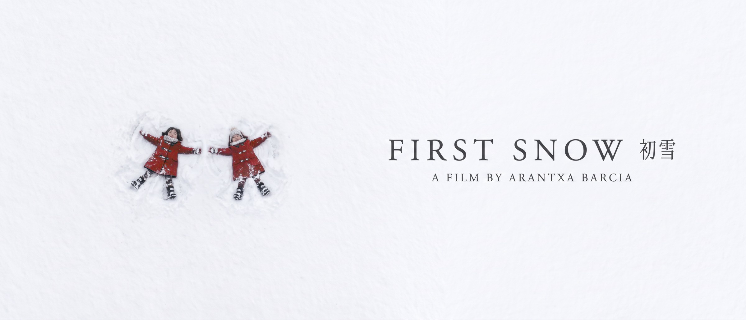 First Snow, two girls in red coats making snow angels