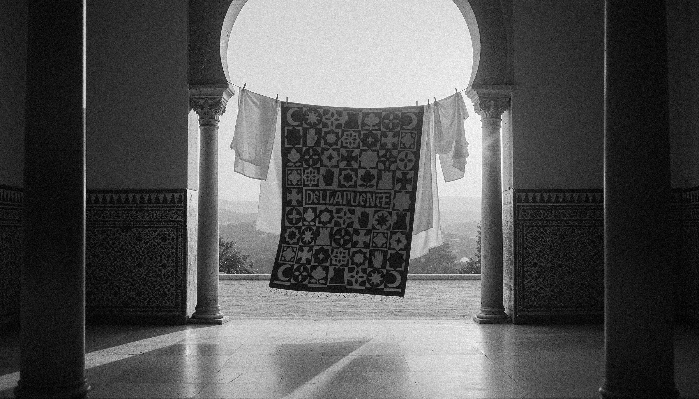 The patterned blanket hung between two columns above the valley