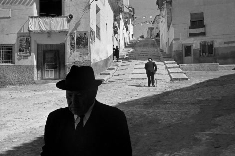 A man in a hat alone in a white street, from Pierre Verger