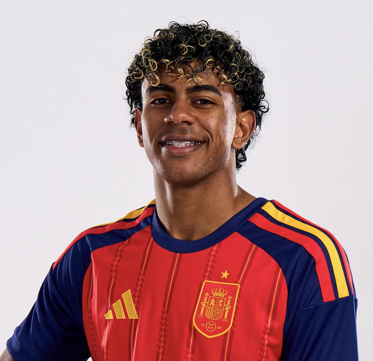 The press photograph of Lamine Yamal in the Spain shirt against a plain white background, used as the likeness reference