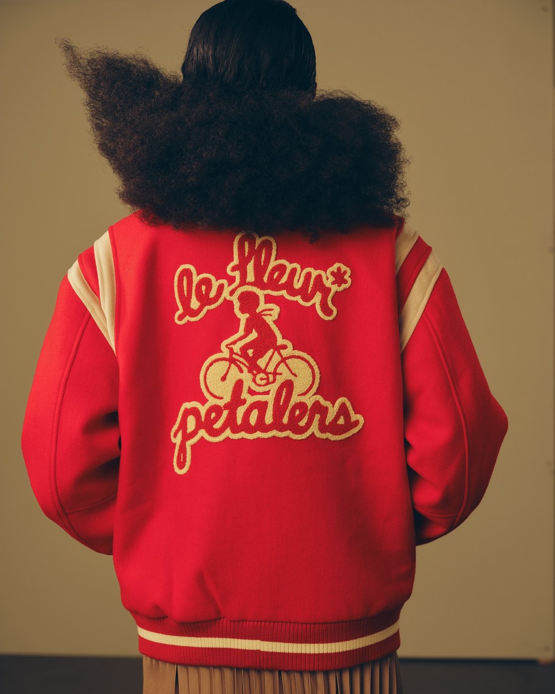 The back of a red varsity jacket chain-stitched le Fleur petalers