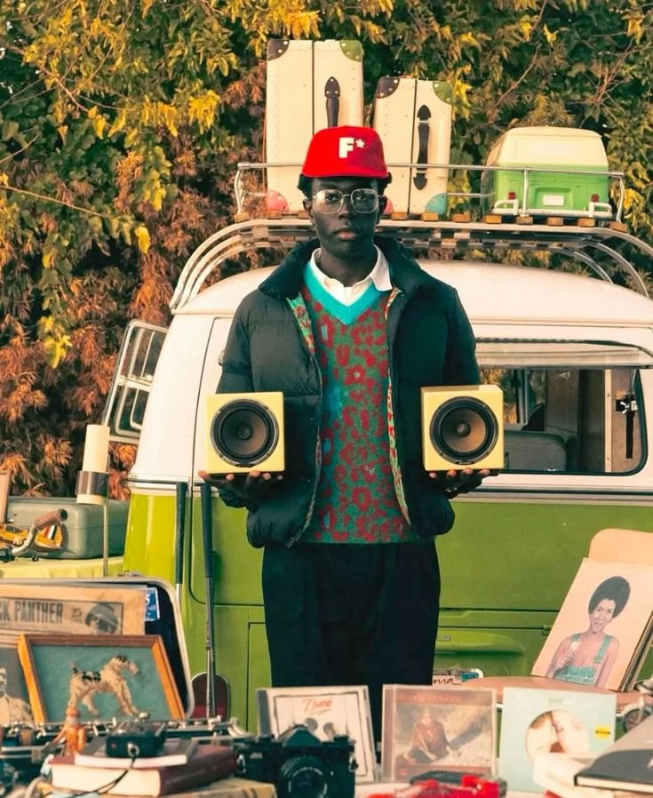 A Golf le Fleur campaign photograph with a van, speakers and framed photographs