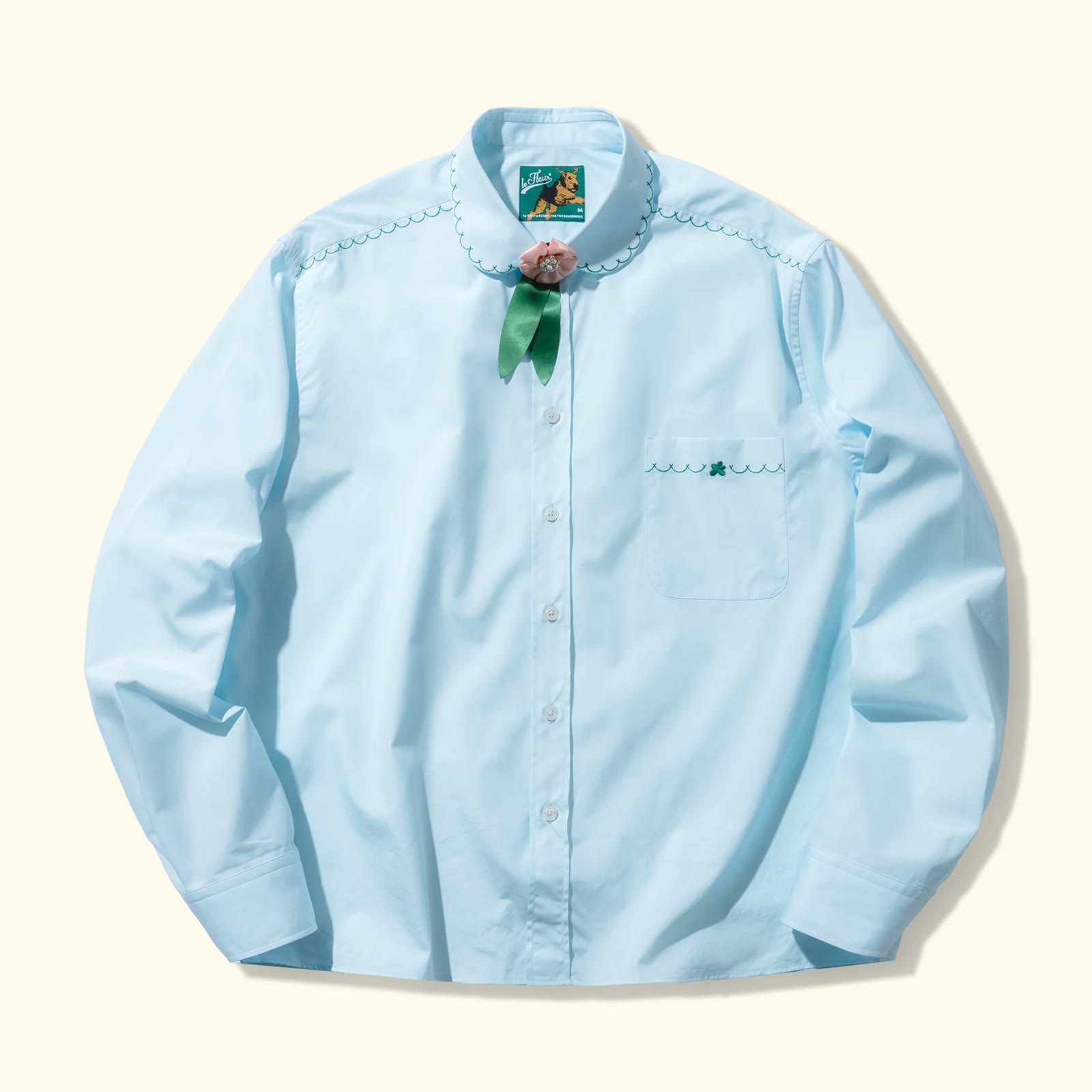 The pale blue Golf le Fleur oxford shirt with its embroidered flower collar, photographed on white