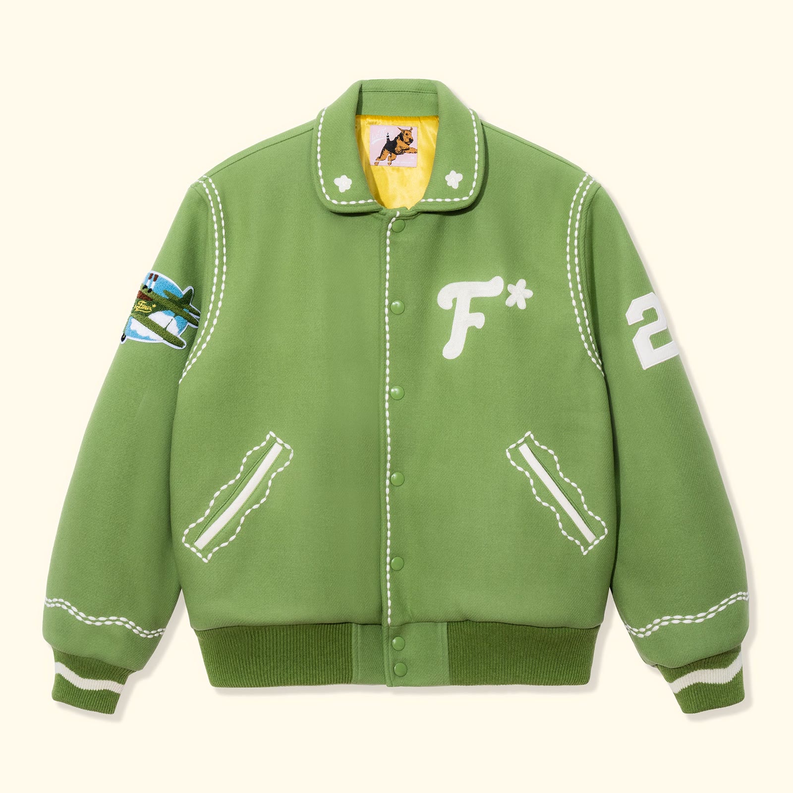 The green Golf le Fleur varsity jacket photographed on white