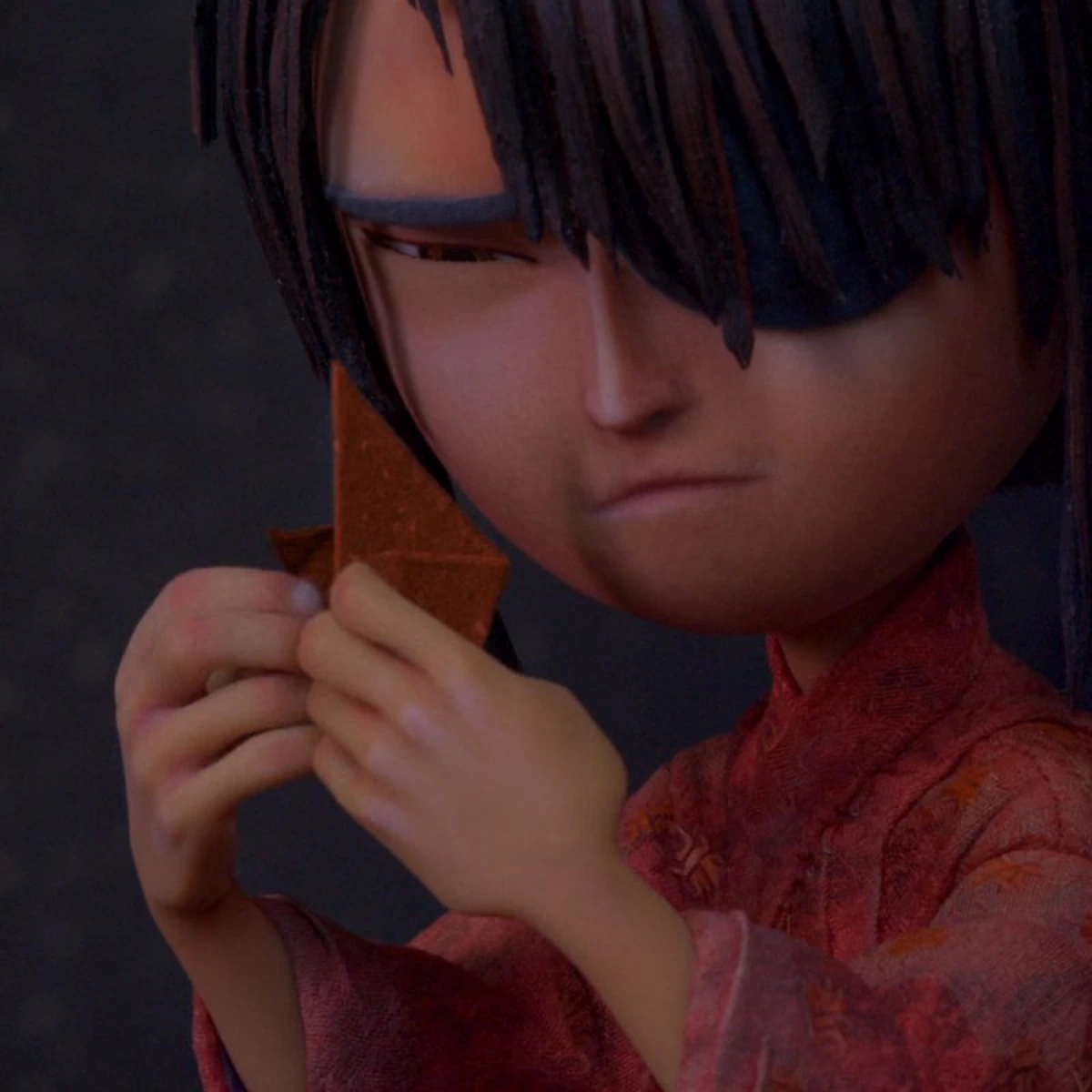 Kubo and the Two Strings: Kubo folding a sheet of paper by hand